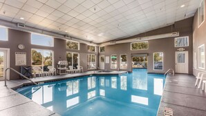An indoor swimming pool with clear pool rules, a clock, and a sign indicating the exit. - Sleep Inn Little River - North Myrtle Beach (Little River)