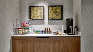 A kitchenette with a coffee maker, tea kettle, and various food items on the counter. - Courtyard By Marriott Nashville Downtown (Nashville)