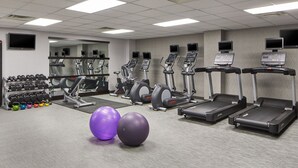 A gym with treadmills, elliptical machines, and free weights. - Courtyard By Marriott Nashville Downtown (Nashville)