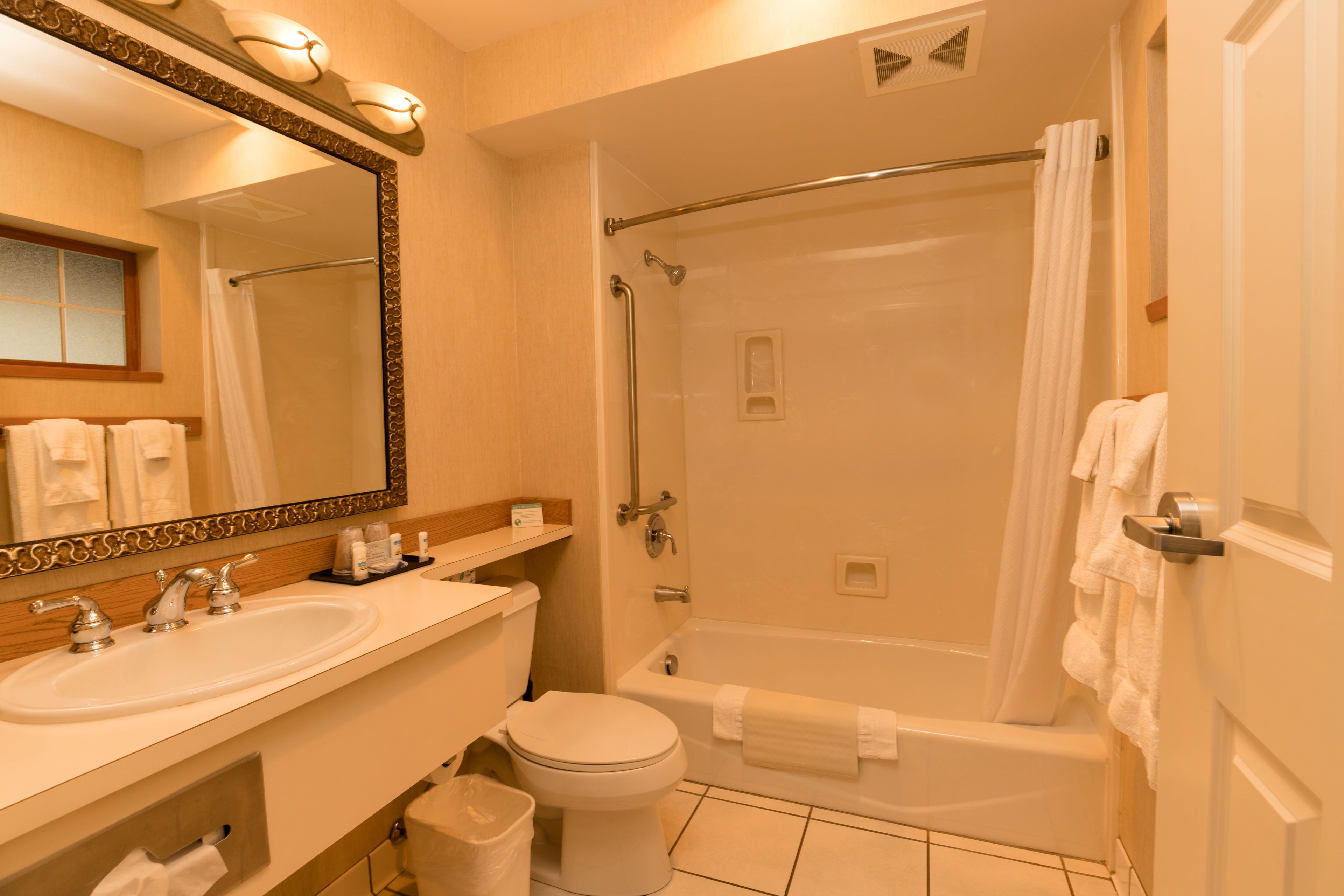 A bathroom with a sink, toilet, and bathtub.