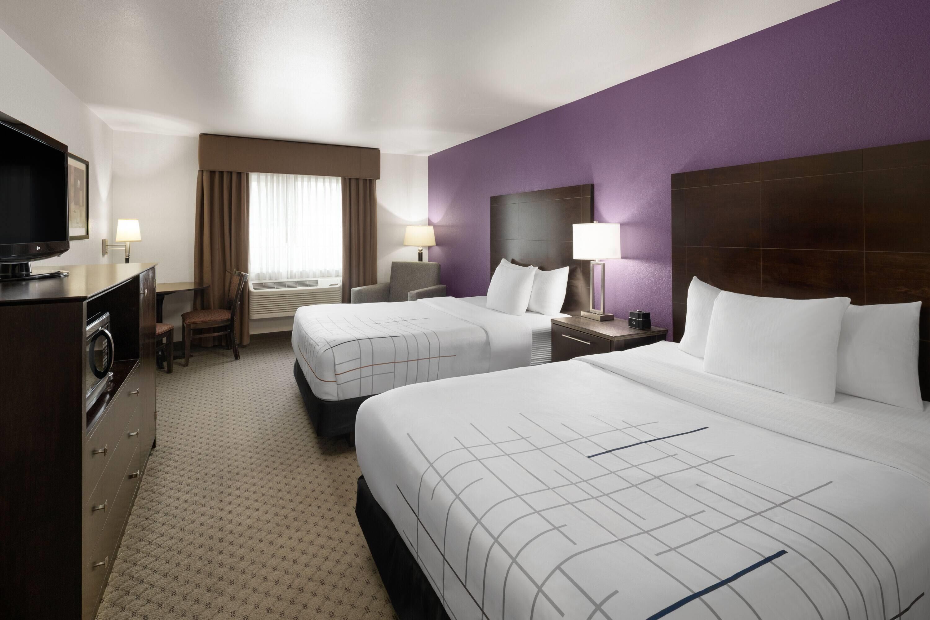 Premium bedding, pillow-top beds, laptop workspace, blackout curtains