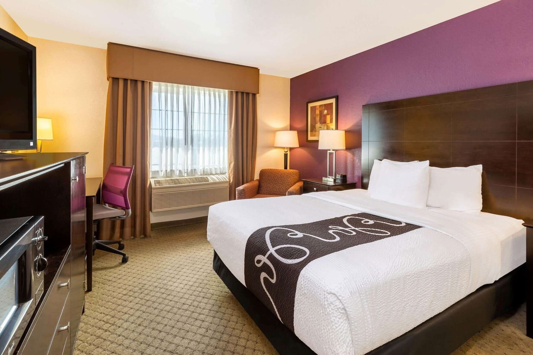 Premium bedding, pillowtop beds, laptop workspace, blackout drapes
