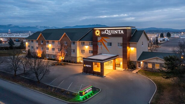 A hotel with a prominent 'La Quinta' sign, a covered entrance, and a parking lot. - La Quinta Inn & Suites by Wyndham Spokane Valley (Spokane Valley)
