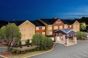 A hotel with a central entrance, multiple windows, and a parking lot. - Garner Hotel Macon West by IHG (Macon)