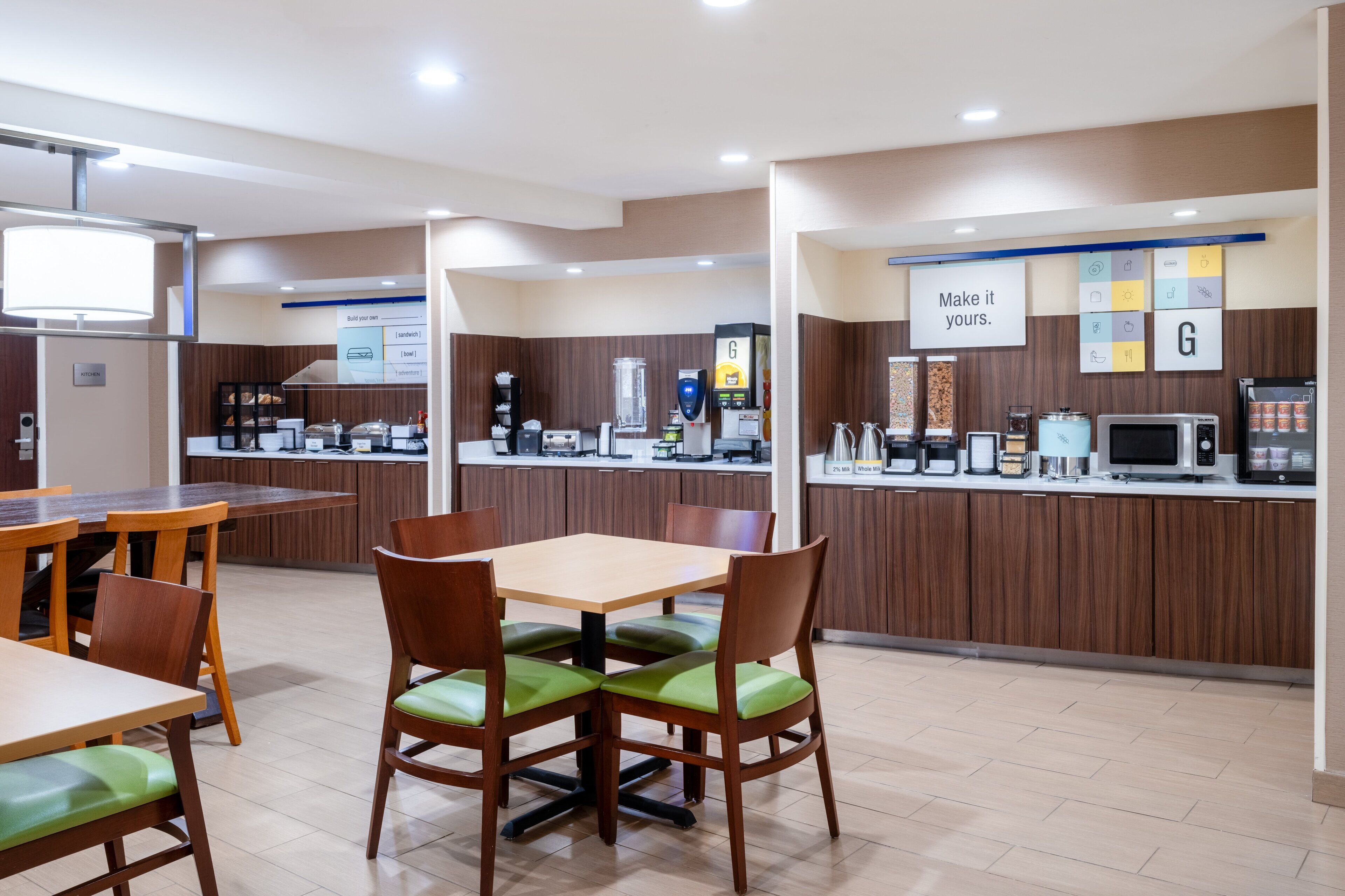 A modern restaurant with wooden furniture and a counter with various food items.