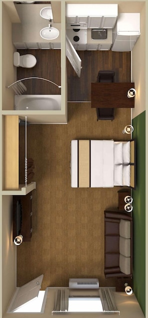 Une chambre d’hôtel compacte comprenant un lit, un petit bureau, un coin salon, une kitchenette et une salle de bain.