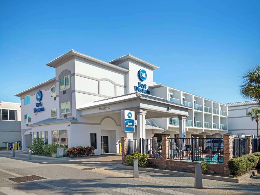 A Best Western hotel with a modern facade, multiple balconies, and a pool area.