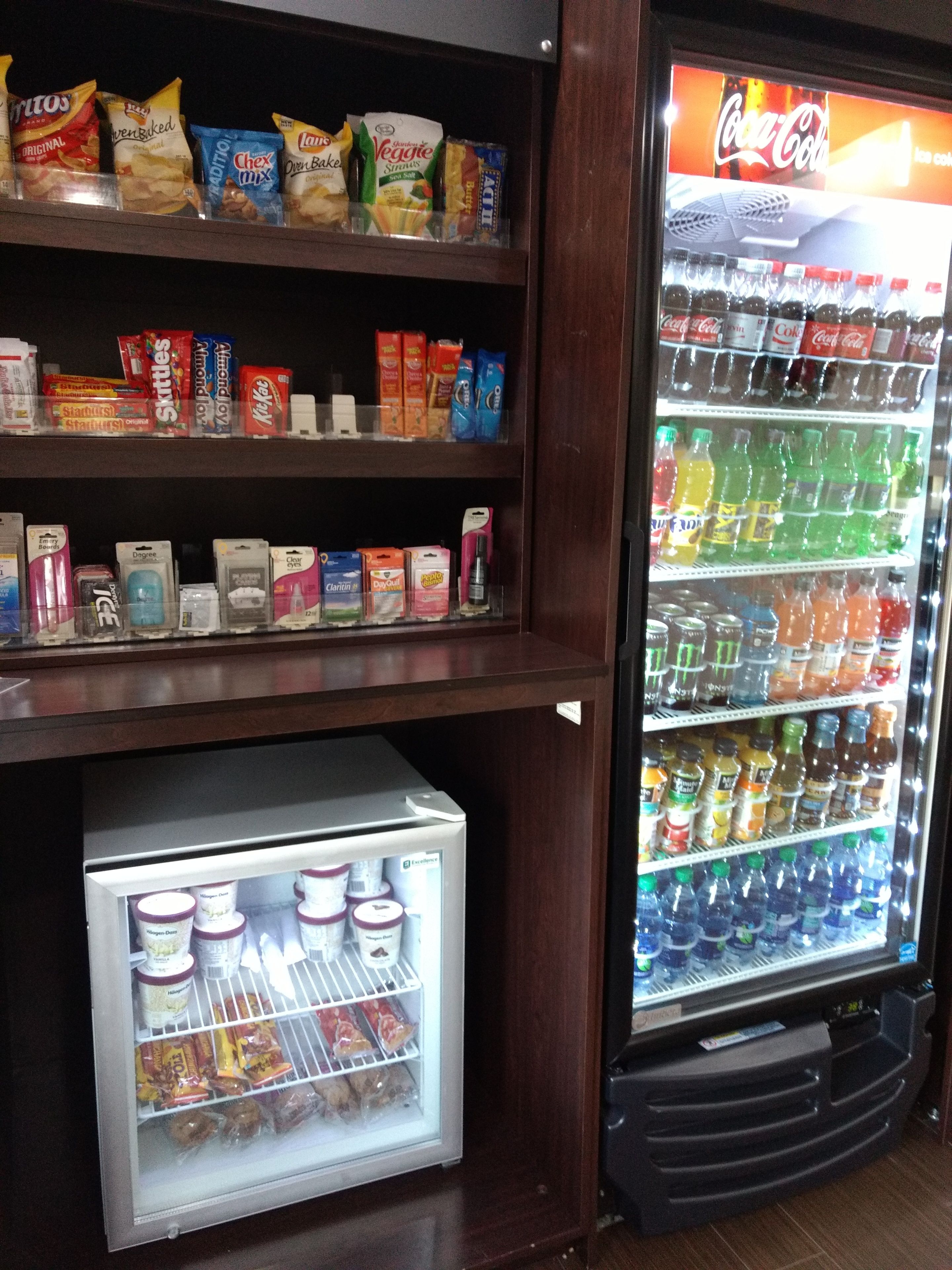 A vending machine stocked with snacks and beverages, including chips, cookies, and sodas.