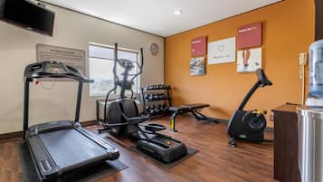 A fitness center with treadmills, an elliptical, and a weight rack.