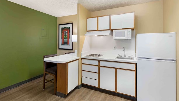 A compact kitchen with a microwave, refrigerator, and sink. - Extended Stay America Select Suites Denver Cherry Creek (Glendale)