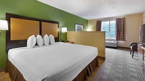 A hotel room with a large bed, a desk, a chair, a TV, and a window with curtains. - Extended Stay America Suites Washington DC Germantown Town C (Germantown)