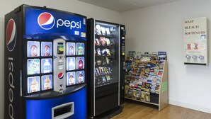 A vending machine area with Pepsi and a soap and bleach display. - HomeTowne Studios By Red Roof Denver - Glendale/ Cherry Creek (Glendale)