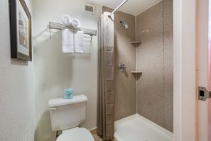 Combined shower/bathtub, deep-soaking bathtub, towels