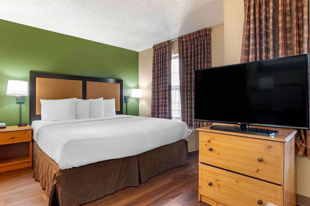 Premium bedding, desk, laptop workspace, iron/ironing board