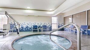 Ein Whirlpool mit Metallgeländern, geflieste Wände und Sitzgelegenheiten darum herum.