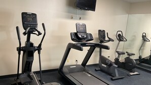A gym with various exercise equipment including treadmills, an elliptical trainer, and a stationary bike. - Days Inn by Wyndham Colorado Springs Airport (Colorado Springs)