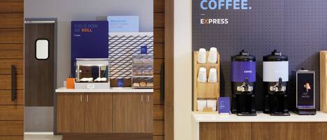 A coffee station with espresso machines and a sign that reads "MUST. HAVE. COFFEE."