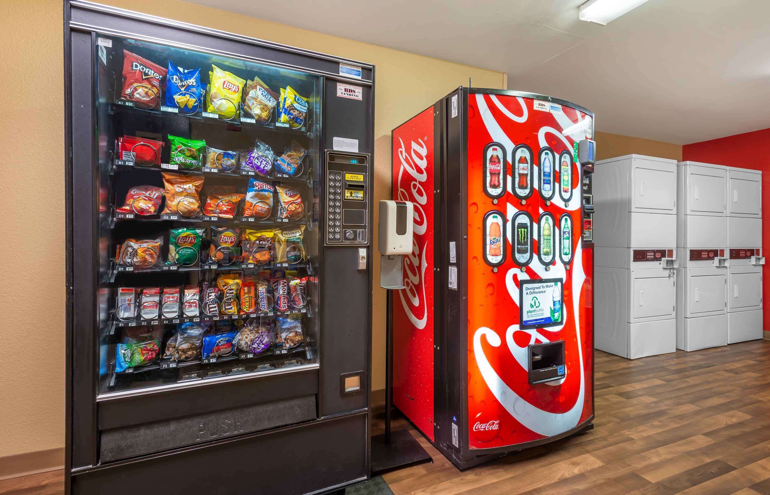 A vending machine with snacks and a Coca-Cola machine.