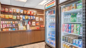 A grocery store interior with snack aisles and a refrigerated beverage section. - Days Inn & Suites by Wyndham Page Lake Powell (Page)