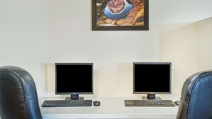 A workspace with two monitors, a keyboard, and a mouse on a desk. - Days Inn & Suites by Wyndham Page Lake Powell (Page)