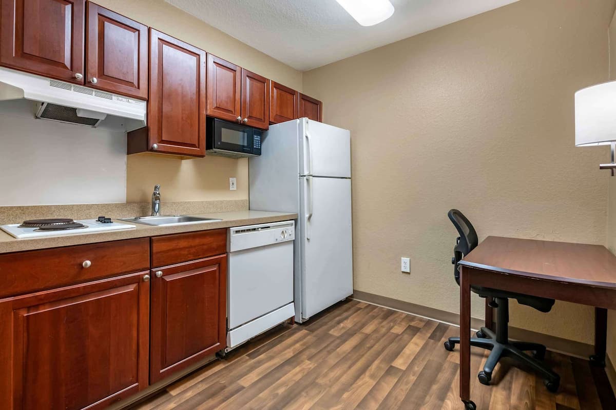 full-sized fridge, microwave, stovetop, coffee/tea maker