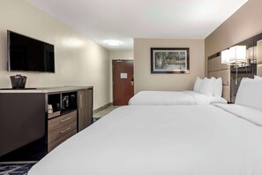 A hotel room with two beds, a TV, a desk, and a framed picture on the wall. - Comfort Inn & Suites Liverpool - Syracuse (Liverpool)