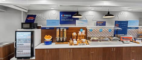 A breakfast area with a digital menu display, various food items, and a sign indicating 'EXPRESS BREAKFAST'.