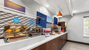 A breakfast bar with various food items and a sign that says "EGG-XACTLY THE START YOU NEED". - Holiday Inn Express Saint Simons Island by IHG (St. Simons Island)