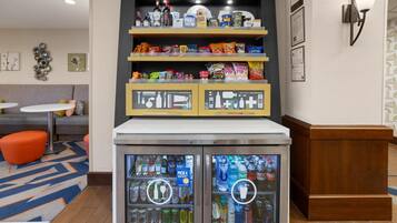 A vending machine with a variety of beverages and snacks.