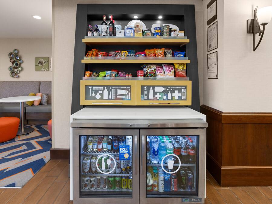A vending machine with a variety of beverages and snacks.