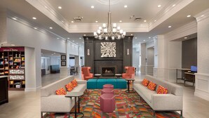 A spacious lobby with a fireplace, seating area, and a bookstore.