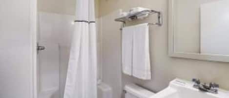 A bathroom with a toilet, sink, and shower curtain.