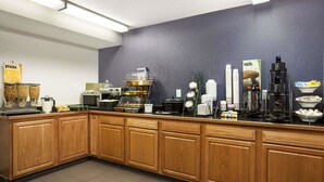 A breakfast bar with various food items, a coffee machine, and a sign that says "cafe." - Microtel Inn by Wyndham Louisville East (Louisville)