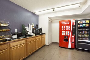 Enjoy a convenient self-service beverage station with snacks and a coffee maker.