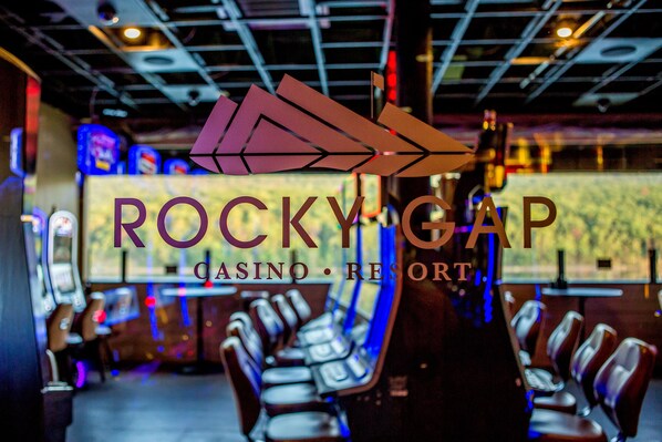 A casino interior with gaming machines and seating areas.