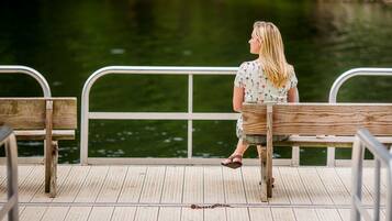 Enjoy serene waterfront views from this tranquil dock, featuring a comfortable bench for taking in the peaceful surroundings.