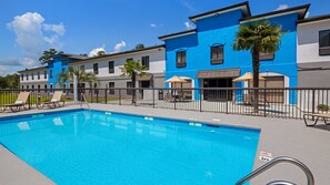 Seasonal outdoor pool, open 10:00 AM to 10:00 PM, pool umbrellas