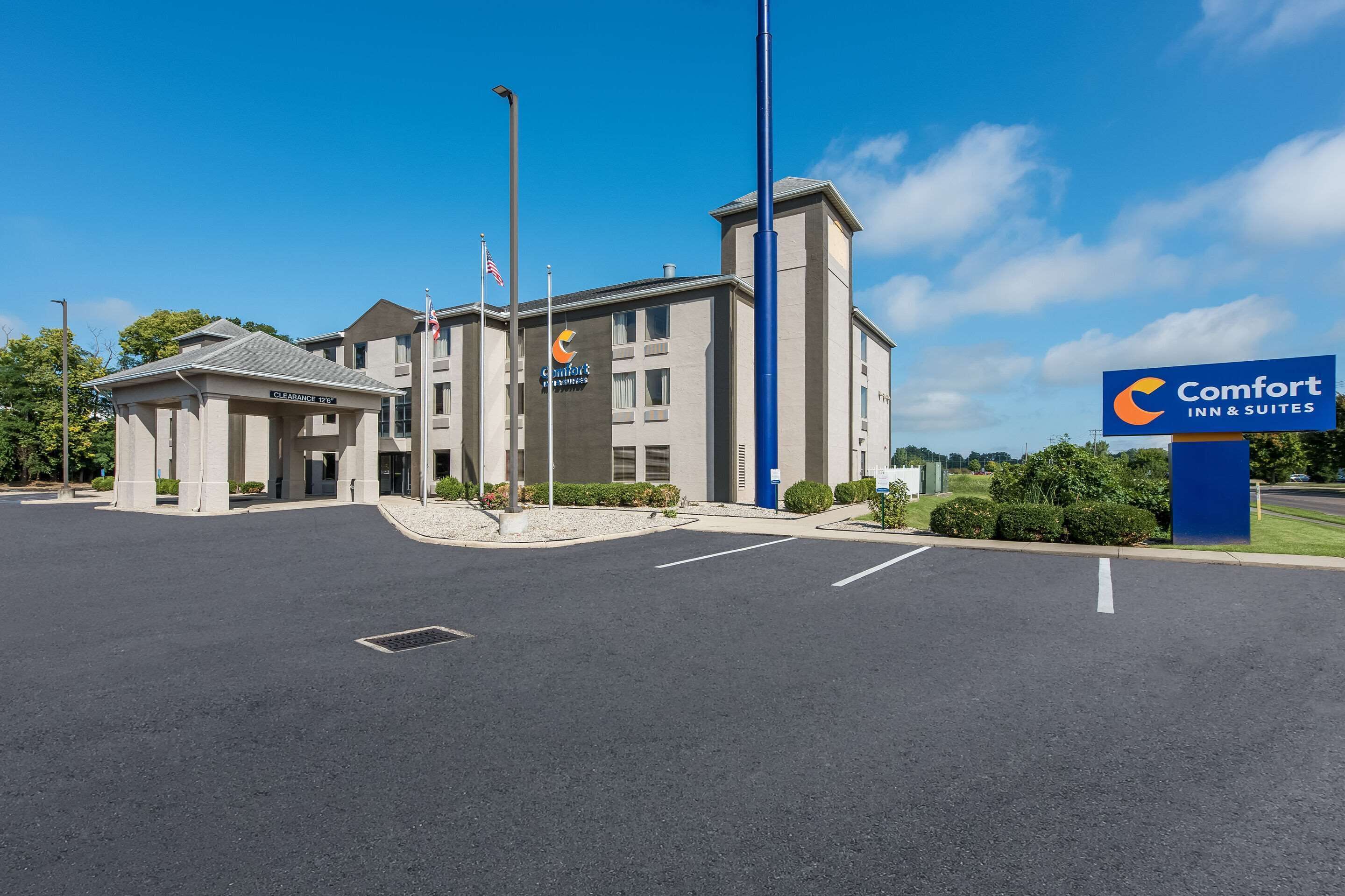 A Comfort Inn & Suites hotel with a clear entrance, parking lot, and a signboard.