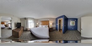 A hotel room with a large bed, a desk, a television, and a bathroom visible through an open door. - Comfort Inn & Suites Tipp City Dayton North I-75 (Tipp City)