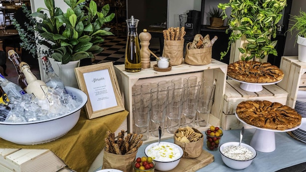 A buffet setup with various food items, a wine cooler, and a sign that reads "Afterwork." - Novotel Firenze Nord Aeroporto (Sesto Fiorentino)