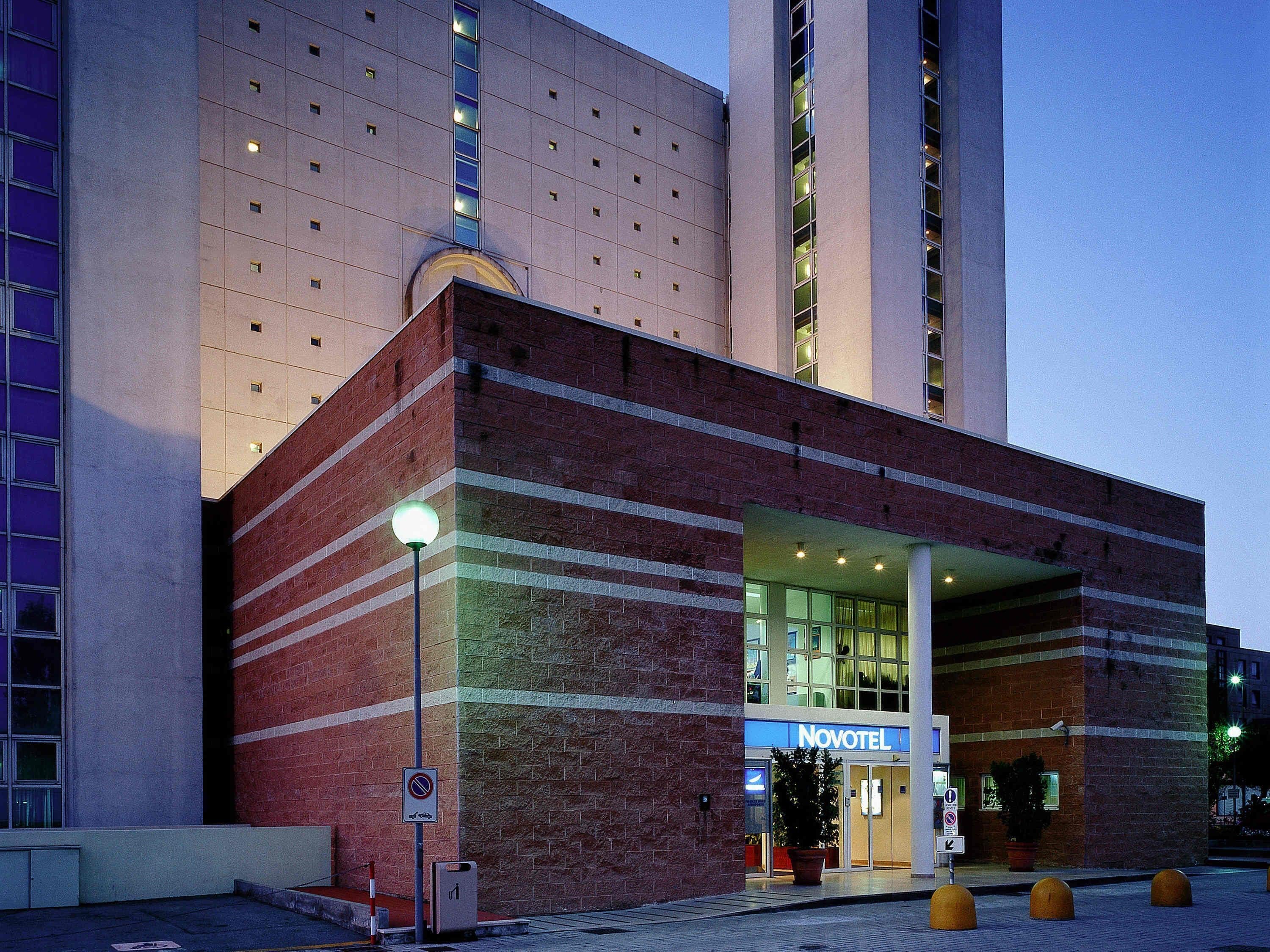 A hotel with a modern facade, a prominent entrance, and a sign reading "Novotel".