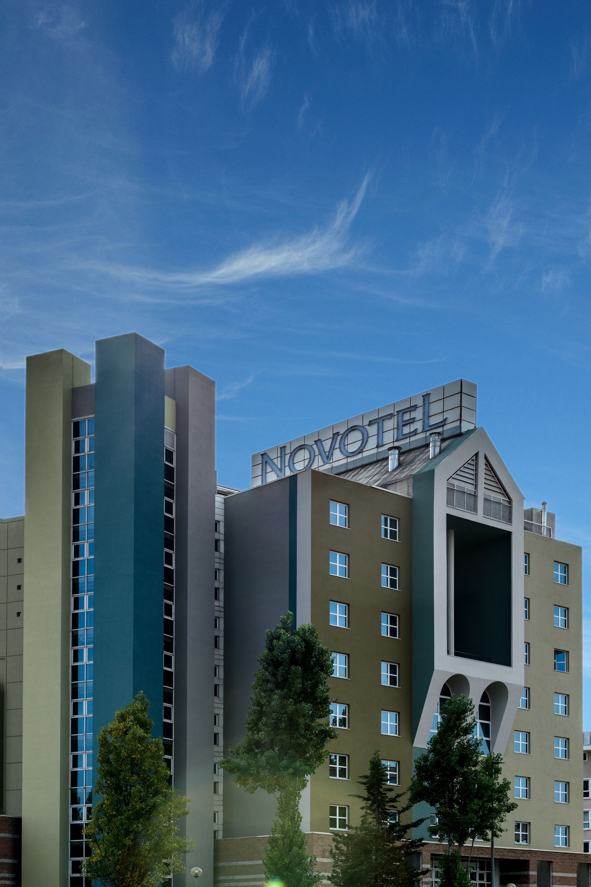 A hotel with a modern design, featuring a prominent 'NOVOTEL' sign on the top.