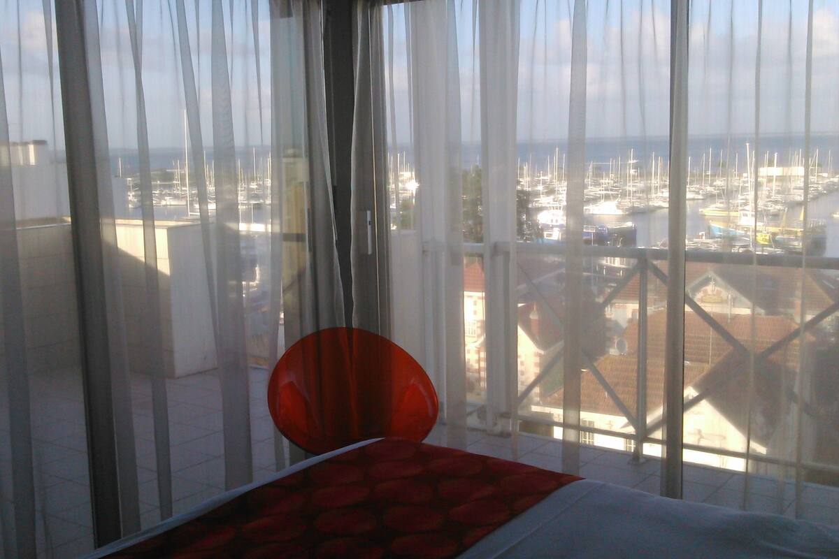 A balcony with a view of a marina.