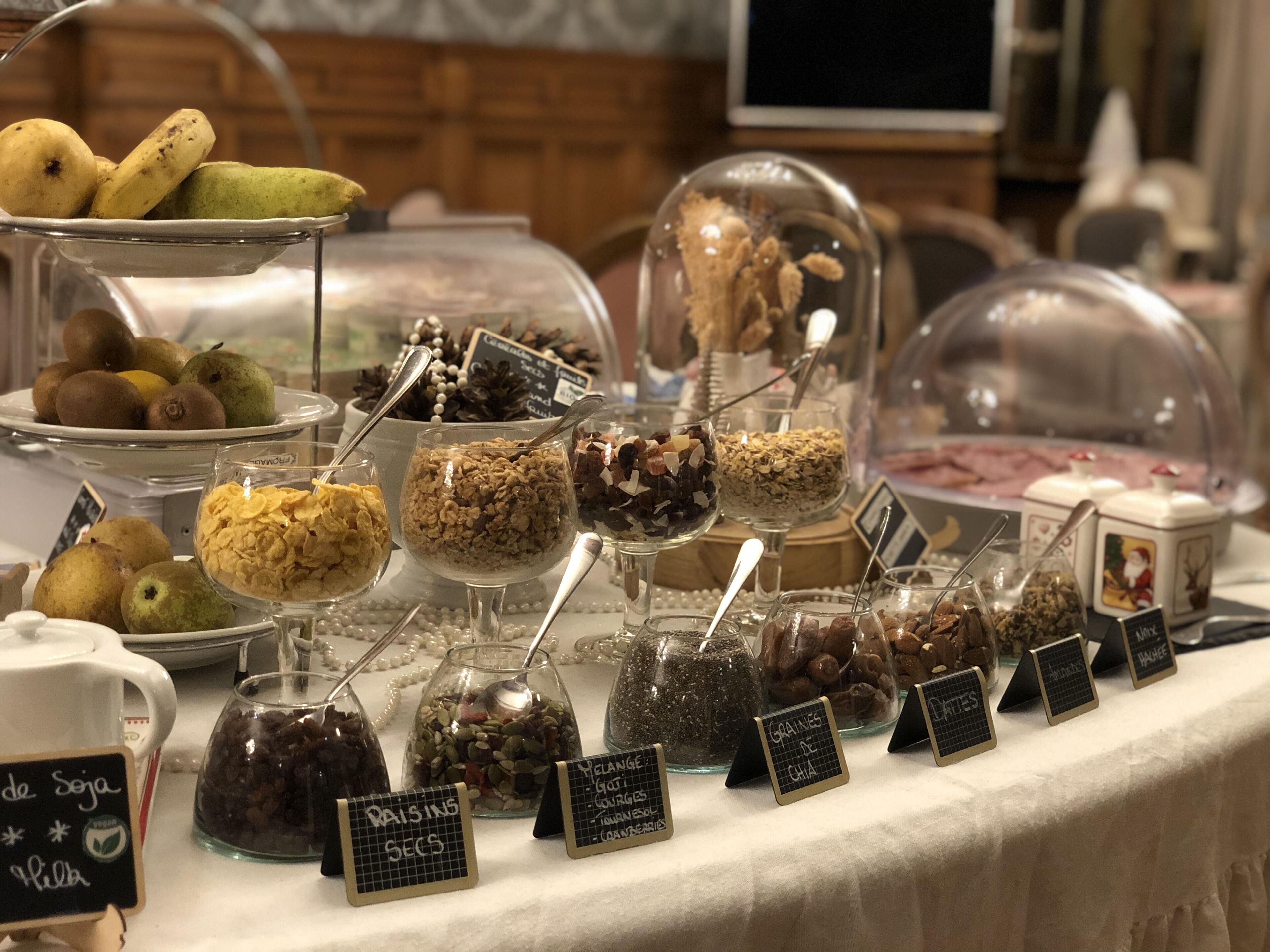 A buffet with various food items including fruits, grains, and nuts.