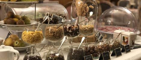 A buffet with various food items including fruits, grains, and nuts.