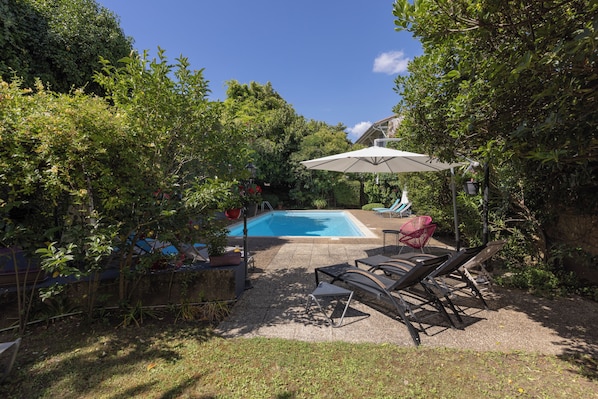 Outdoor pool, open 10:00 AM to 9:00 PM, pool umbrellas