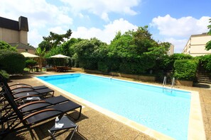 Outdoor pool, open 10:00 AM to 9:00 PM, pool umbrellas