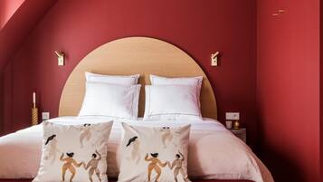 Un dormitorio con cama de madera, paredes rojas y techo curvo.