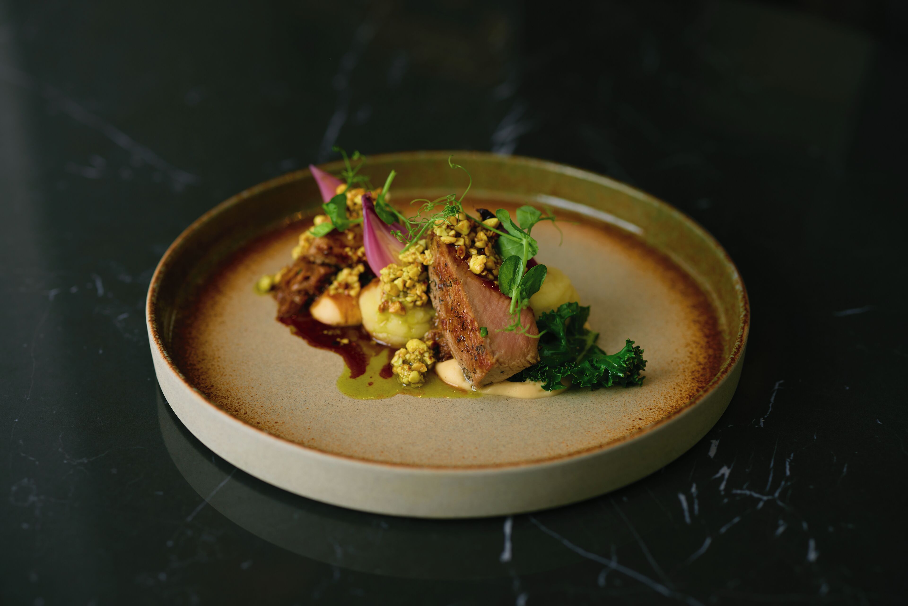 A plate of food with various ingredients and garnishes.