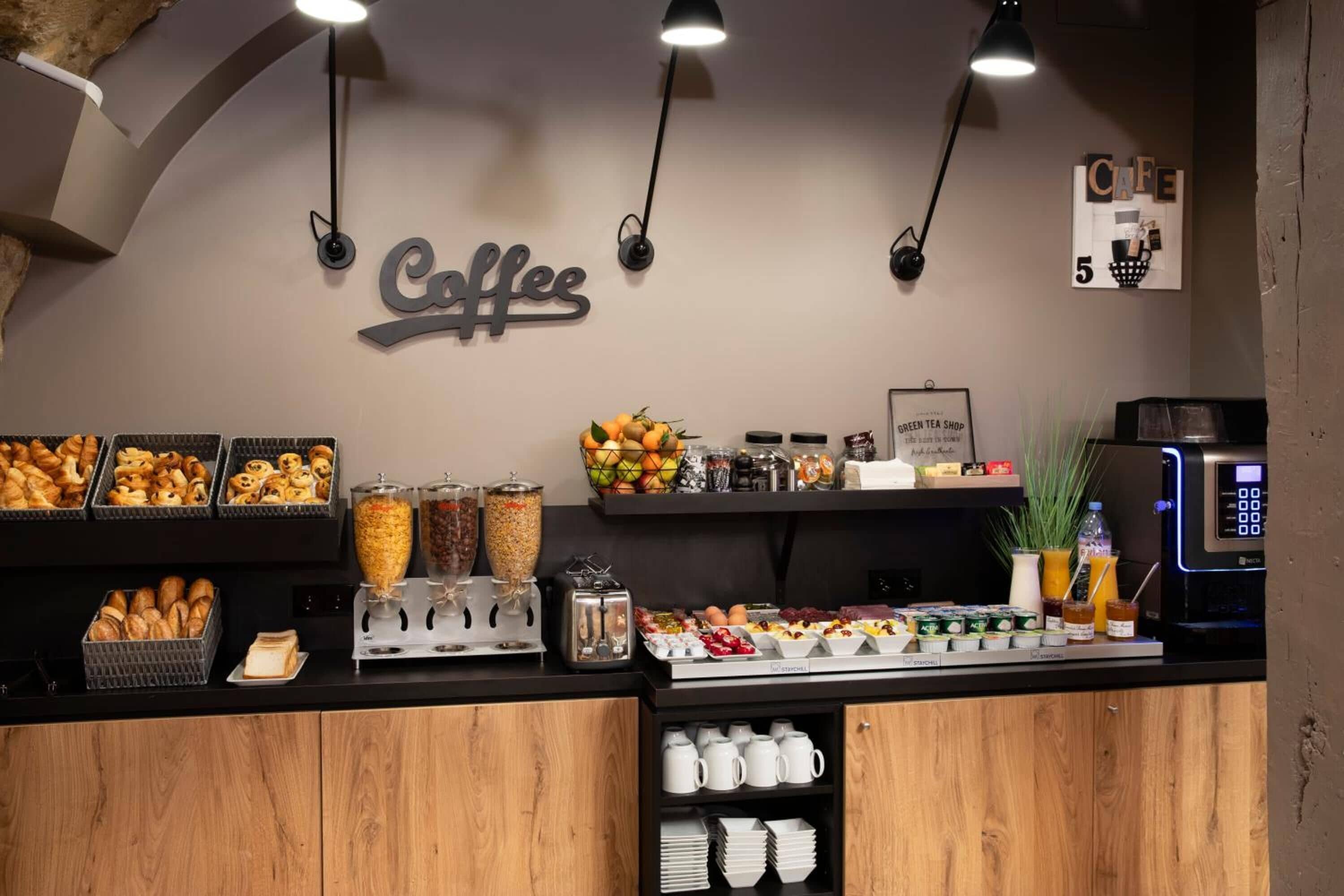 A coffee station with various food items, a coffee sign, and a wall-mounted number '5'.